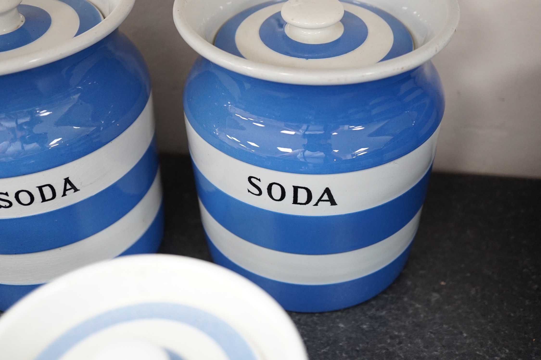 T.G.Green Cornish Kitchenware, eight lidded storage jars comprising Washing-Soda, Soda, Starch, Haricot Beans, Quaker Oats, Oatmeal, Lentils and one unnamed, largest 18cm high, mainly Black Shield marks. Condition - fair
